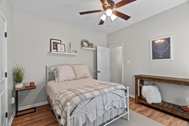 bedroom with baseboards, ceiling fan, and wood finished floors
