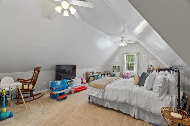 carpeted bedroom with ceiling fan and vaulted ceiling
