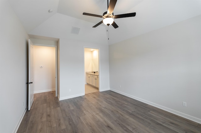 unfurnished bedroom with dark wood-style flooring, ceiling fan, baseboards, lofted ceiling, and visible vents