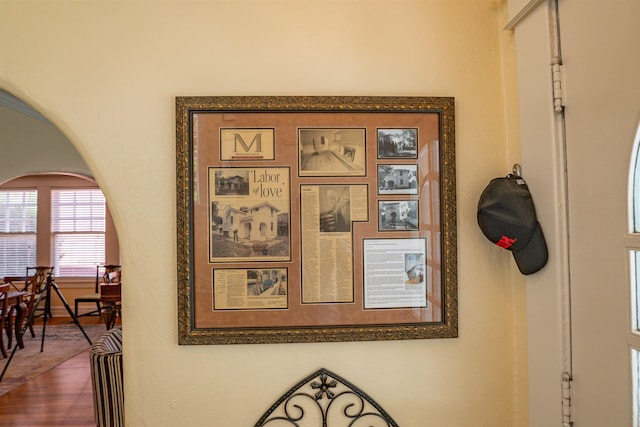 room details featuring arched walkways and wood finished floors