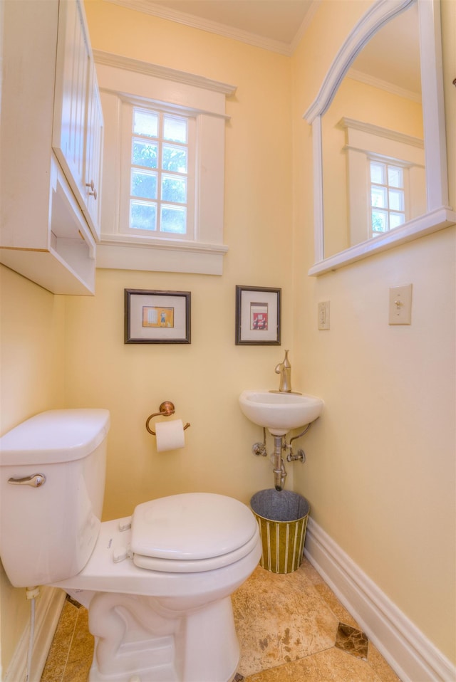 bathroom with plenty of natural light, ornamental molding, and toilet
