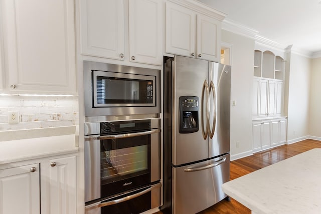 7298 Mont Blanc Dr, Germantown, TN 38138 - kitchen with light countertops, appliances with stainless steel finishes, white cabinets, and a warming drawer
