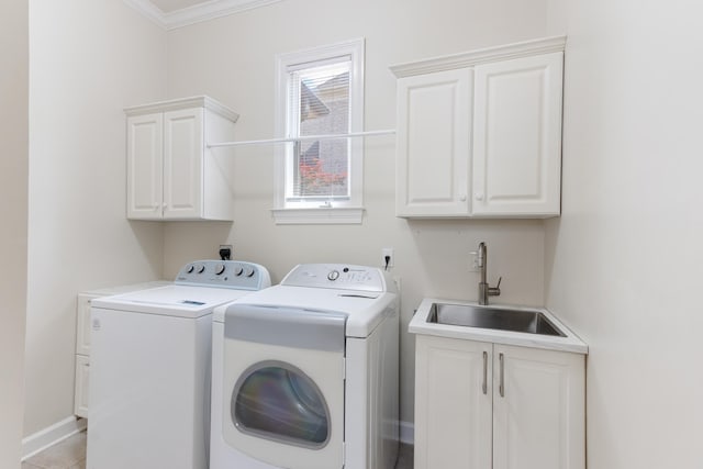 7298 Mont Blanc Dr, Germantown, TN 38138 - clothes washing area with cabinet space, a sink, separate washer and dryer, baseboards, and ornamental molding