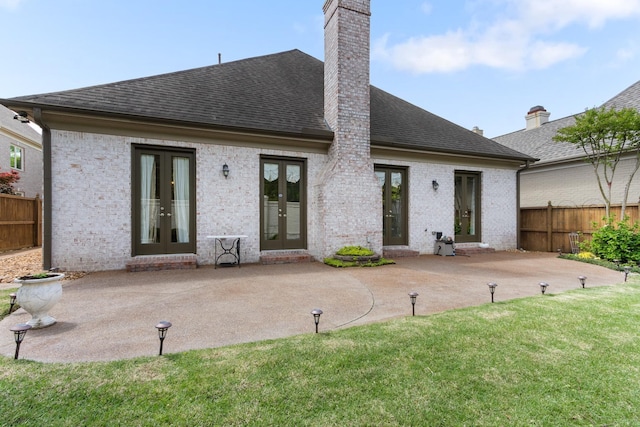 7298 Mont Blanc Dr, Germantown, TN 38138 - rear view of house with fence, a patio, french doors, a chimney, and a shingled roof