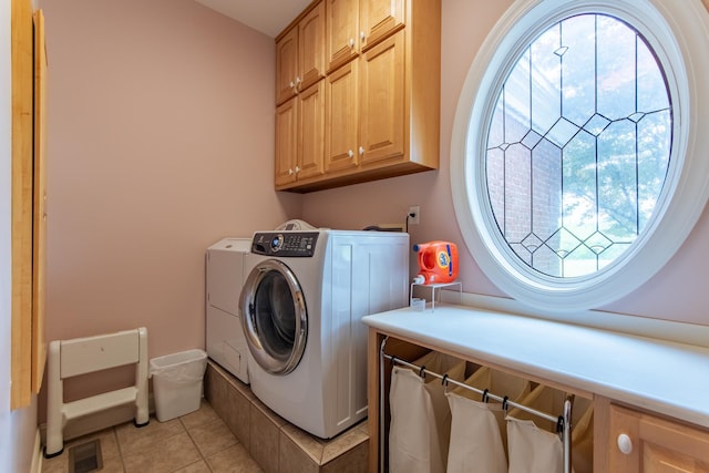 4265 Charlie Pounds Rd, Stantonville, TN 38379 - laundry area with visible vents, cabinet space, light tile patterned floors, and washer and dryer