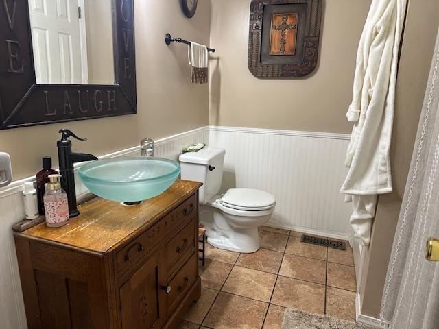 85 Two Boys Rd, Savannah, TN 38372 - bathroom featuring wainscoting, vanity, toilet, and tile patterned floors