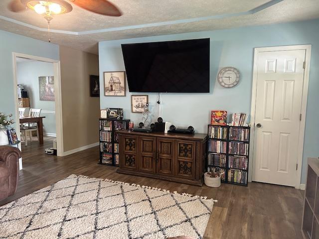 85 Two Boys Rd, Savannah, TN 38372 - living room with wood finished floors, a ceiling fan, baseboards, and a textured ceiling