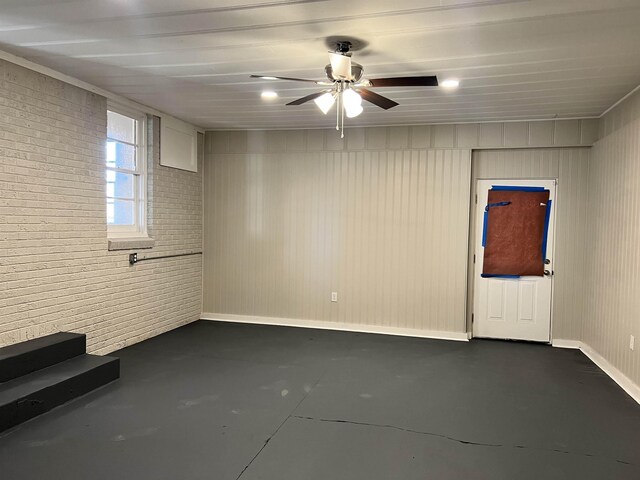 410 Pinhook Dr, Savannah, TN 38372 - unfurnished room featuring concrete floors, ceiling fan, and brick wall