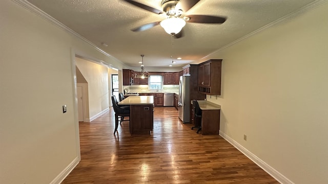 kitchen with a kitchen island, dark brown cabinets, a breakfast bar area, light countertops, and appliances with stainless steel finishes