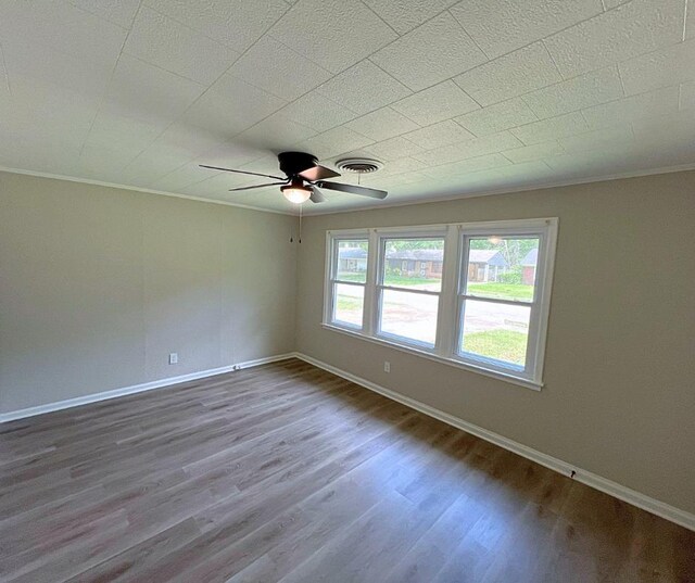 4485 Dunn Rd, Memphis, TN 38117 - spare room with crown molding, ceiling fan, visible vents, and wood finished floors