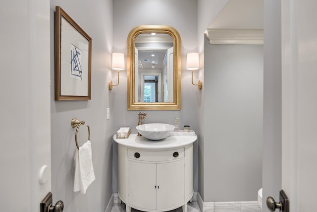 bathroom with vanity, baseboards, and toilet
