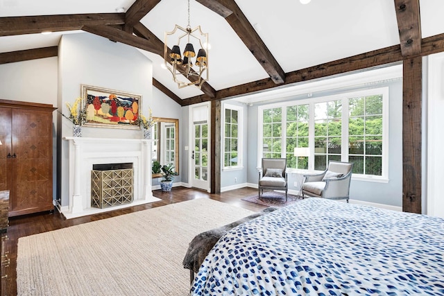 bedroom with lofted ceiling with beams, an inviting chandelier, baseboards, a fireplace with flush hearth, and dark wood-style floors