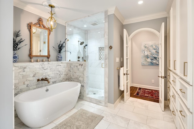 full bathroom featuring crown molding, a freestanding tub, baseboards, recessed lighting, and a shower stall