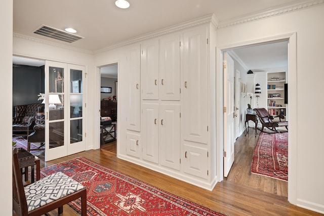 corridor with visible vents, wood finished floors, and french doors
