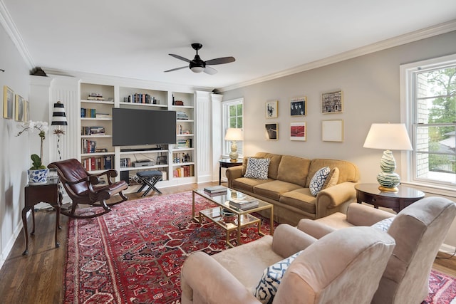 living area featuring crown molding, a ceiling fan, a wealth of natural light, and wood finished floors