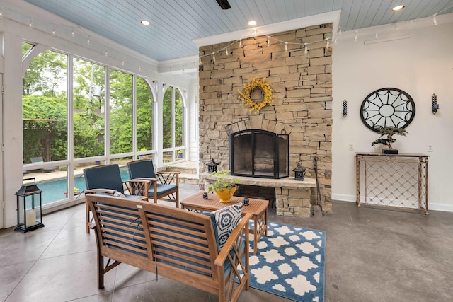 living room with wood ceiling, a wealth of natural light, and a fireplace