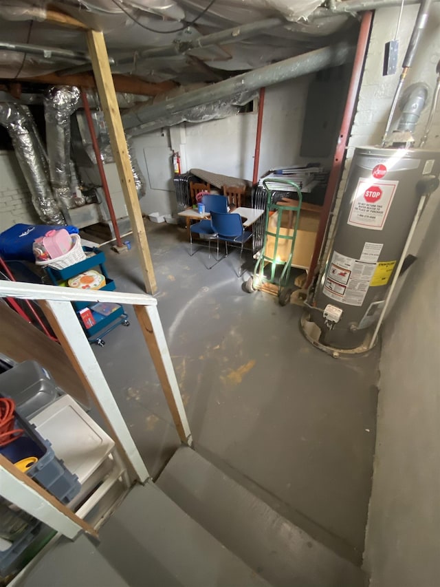 unfinished below grade area featuring water heater