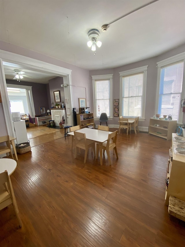 dining space featuring a ceiling fan and wood finished floors