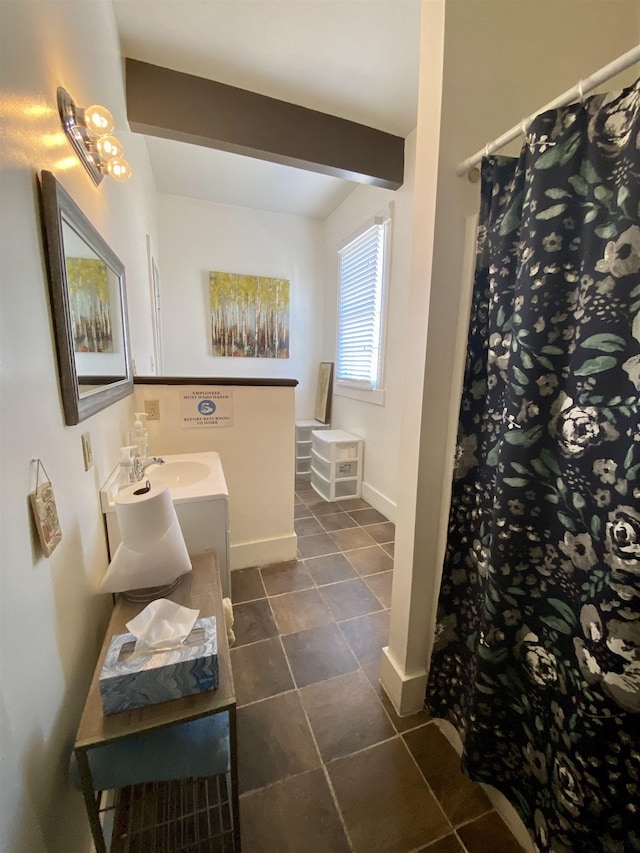 bathroom with baseboards, double vanity, tile patterned floors, and a shower with curtain