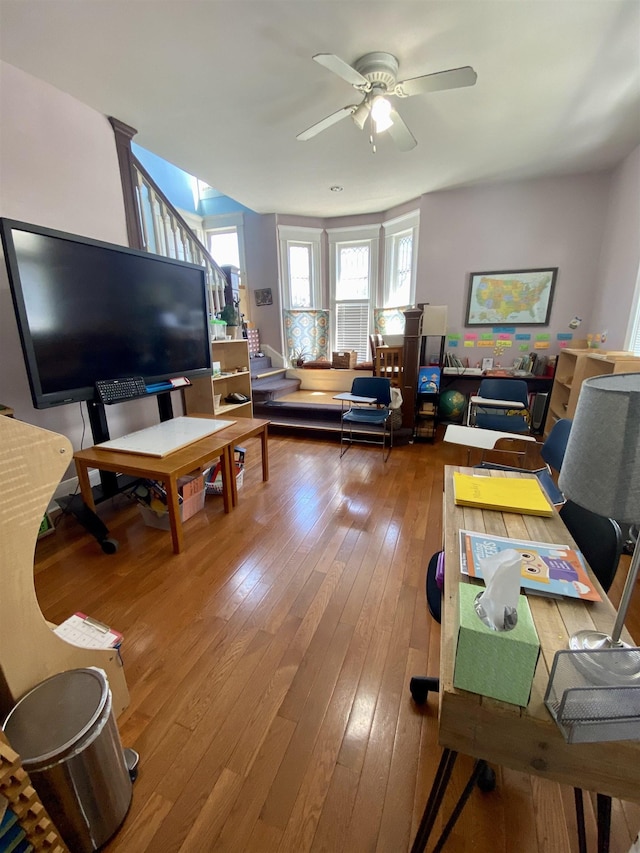 living room with ceiling fan and hardwood / wood-style flooring