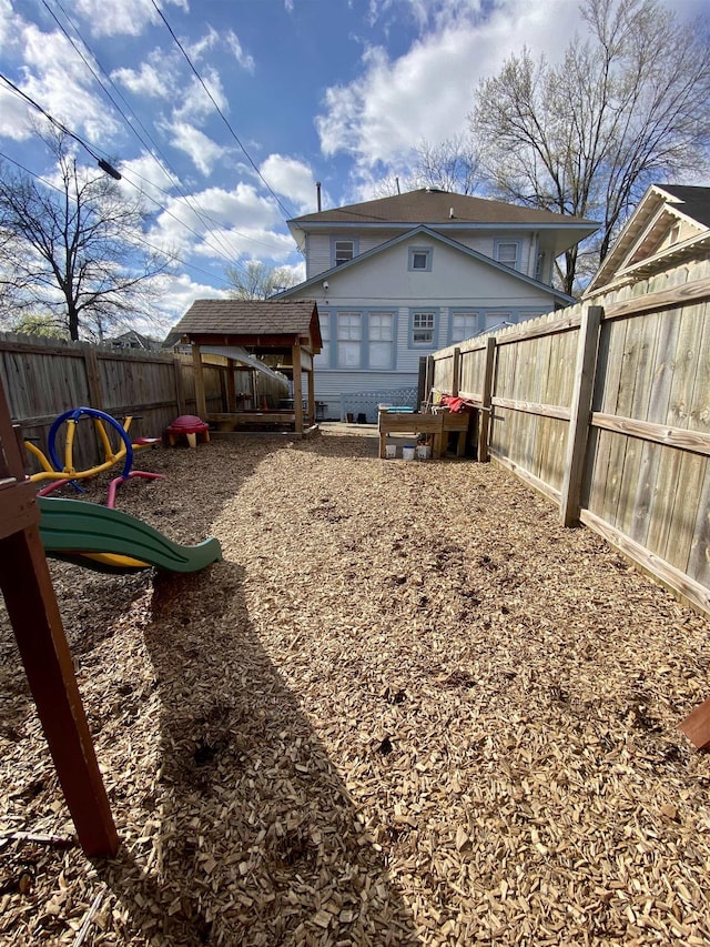 rear view of property with a fenced backyard