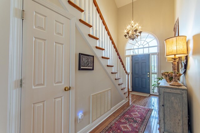164B Aquaticview Way, Savannah, TN 38372 - entrance foyer with visible vents, a notable chandelier, a high ceiling, stairs, and hardwood / wood-style floors