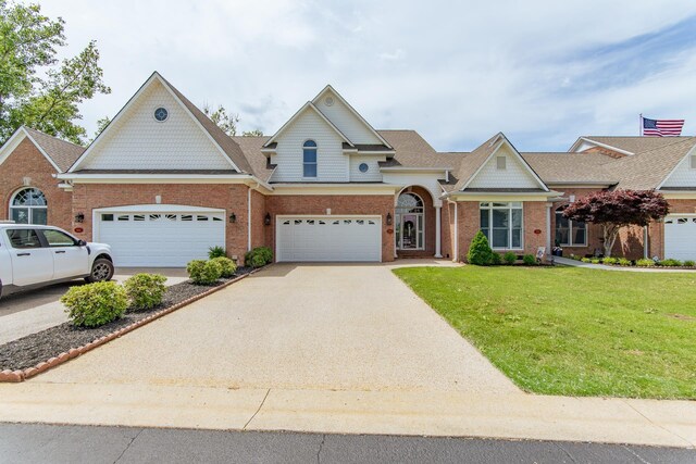 164B Aquaticview Way, Savannah, TN 38372 - view of front of house featuring brick siding, a shingled roof, a front lawn, and driveway