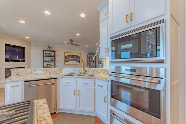 164B Aquaticview Way, Savannah, TN 38372 - kitchen with a sink, appliances with stainless steel finishes, crown molding, and a peninsula