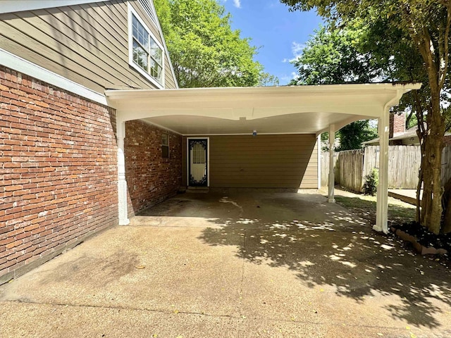 view of car parking featuring fence and concrete driveway