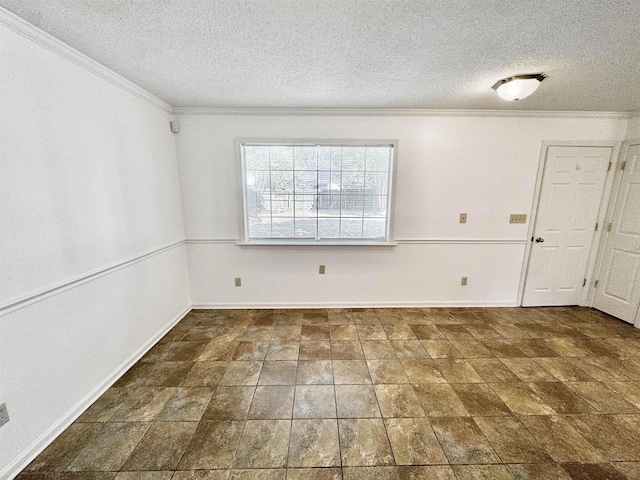 spare room with crown molding, a textured ceiling, baseboards, and stone finish floor