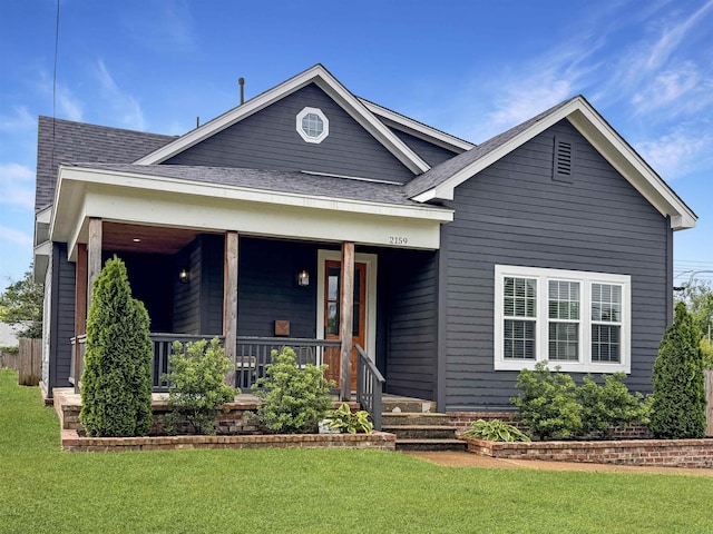 view of front of property with a porch and a front lawn