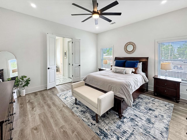 bedroom with recessed lighting, baseboards, light wood-type flooring, and visible vents