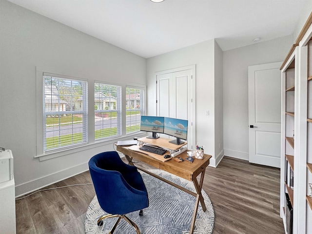 office space with dark wood-style flooring and baseboards