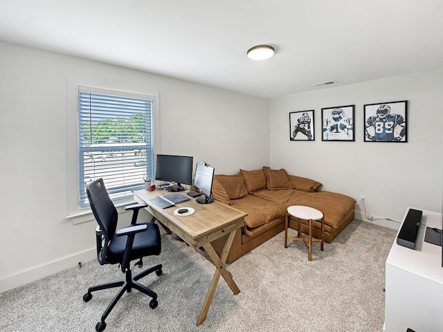 office space with visible vents, baseboards, and light carpet