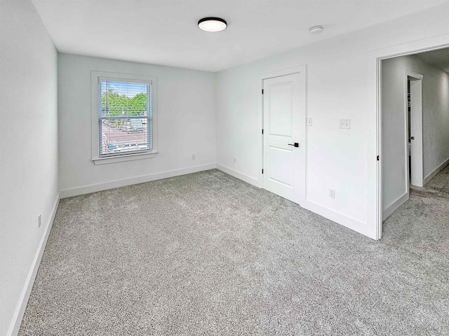 unfurnished bedroom with baseboards and carpet flooring