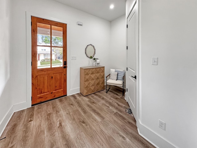 entryway with recessed lighting, baseboards, and wood finished floors