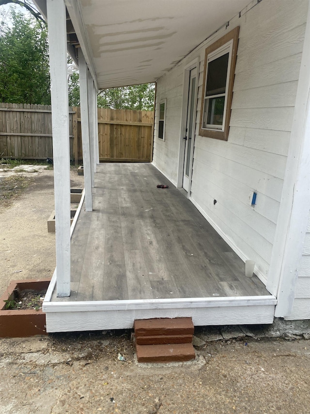 wooden terrace featuring fence