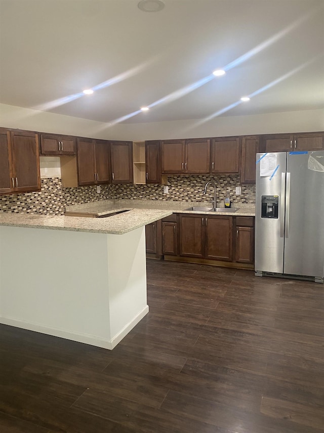 kitchen with stainless steel refrigerator with ice dispenser, a sink, backsplash, and recessed lighting