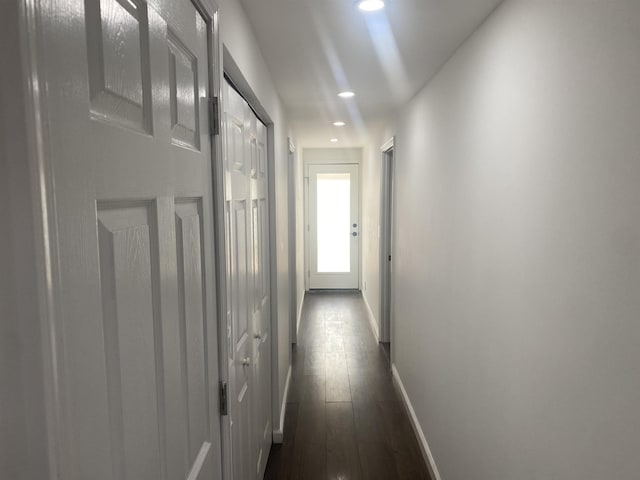 hall featuring recessed lighting, baseboards, and dark wood-style floors