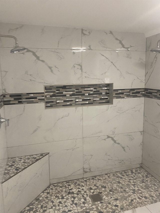 bathroom with a tile shower