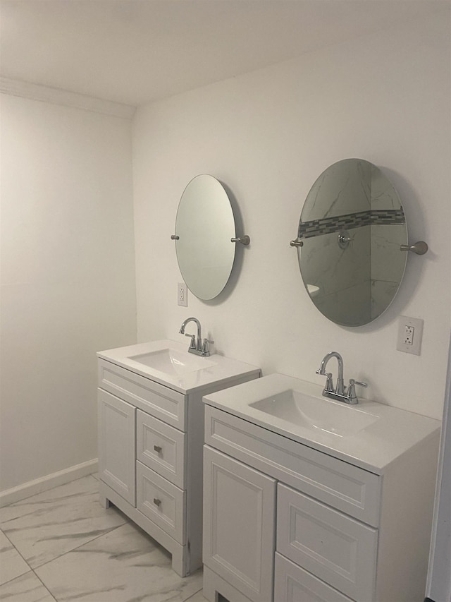 bathroom with a sink, two vanities, and marble finish floor
