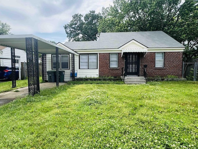 ranch-style house with fence, a carport, brick siding, and a front yard
