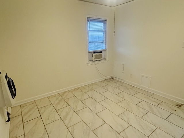 unfurnished room featuring baseboards, marble finish floor, and cooling unit