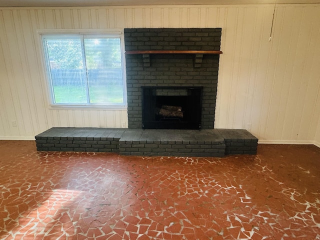 details featuring baseboards and a brick fireplace