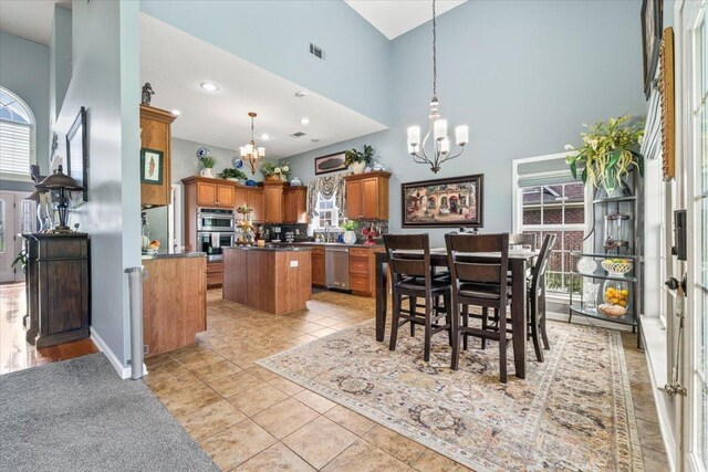235 Fairoaks Dr, Oakland, TN 38060 - dining space featuring light tile patterned floors, a chandelier, a wealth of natural light, and a towering ceiling