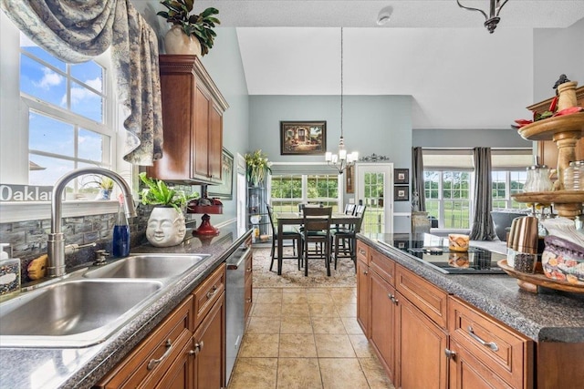 235 Fairoaks Dr, Oakland, TN 38060 - kitchen with dark countertops, brown cabinets, a sink, black electric stovetop, and an inviting chandelier
