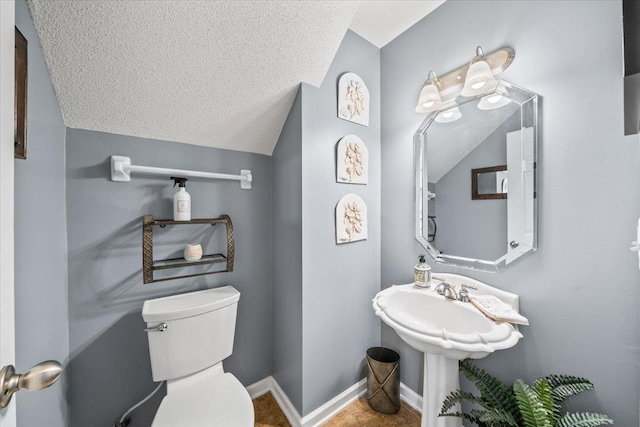 235 Fairoaks Dr, Oakland, TN 38060 - half bathroom with toilet, a textured ceiling, vaulted ceiling, and baseboards