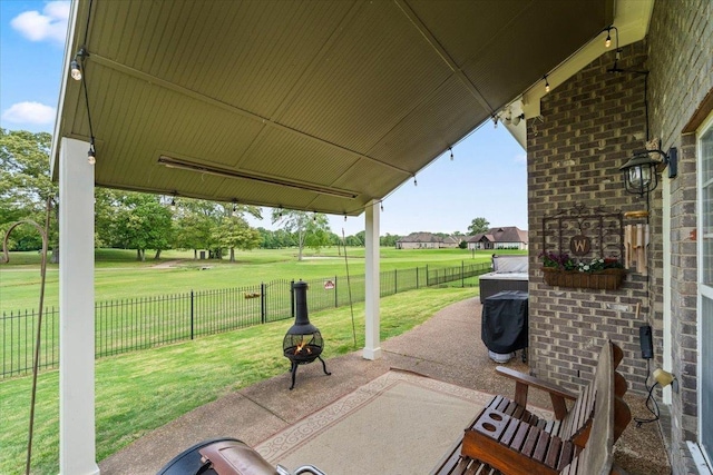235 Fairoaks Dr, Oakland, TN 38060 - view of patio featuring a fenced backyard and a fire pit