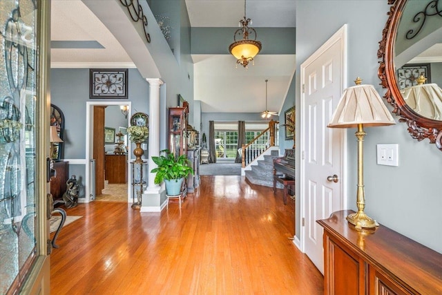 235 Fairoaks Dr, Oakland, TN 38060 - foyer with stairs, a high ceiling, decorative columns, and light wood-style flooring