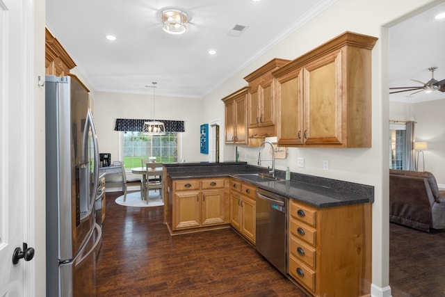 kitchen featuring ceiling fan, crown molding, appliances with stainless steel finishes, dark wood finished floors, and a sink